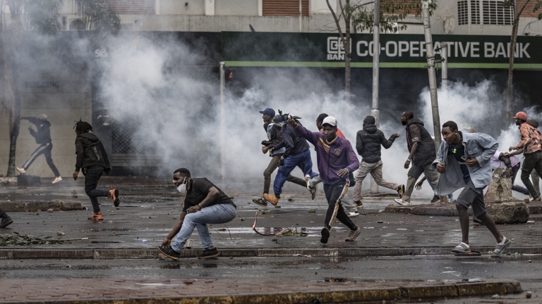 NAIROBI, KENYA - JUNE 25: Protesters run through tear gas during the Gen Z protest on June 25, 2025 in Nairobi, Kenya. Today's demonstration marks the first anniversary of the 2024 anti-government protests against the Finance Bill that left more than 60 people dead. The violence drew widespread condemnation over the use of force by the Kenyan security agencies. (Photo by Michel Lunanga/Getty Images)