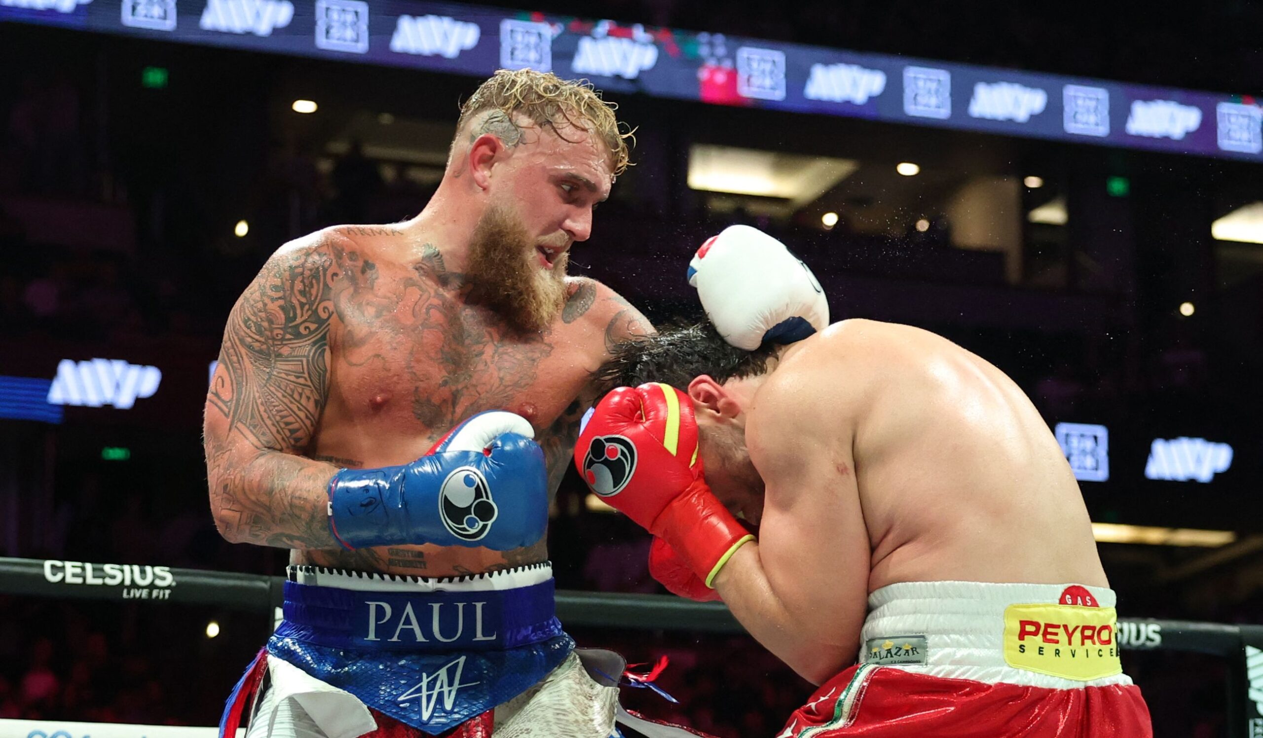USA's Jake Paul (L) and Mexico's Julio Cesar Chavez Jr. fight during their cruiserweight boxing bout at the Honda Center in Anaheim, California, on June 28, 2025. (Photo by Patrick T. Fallon / AFP)