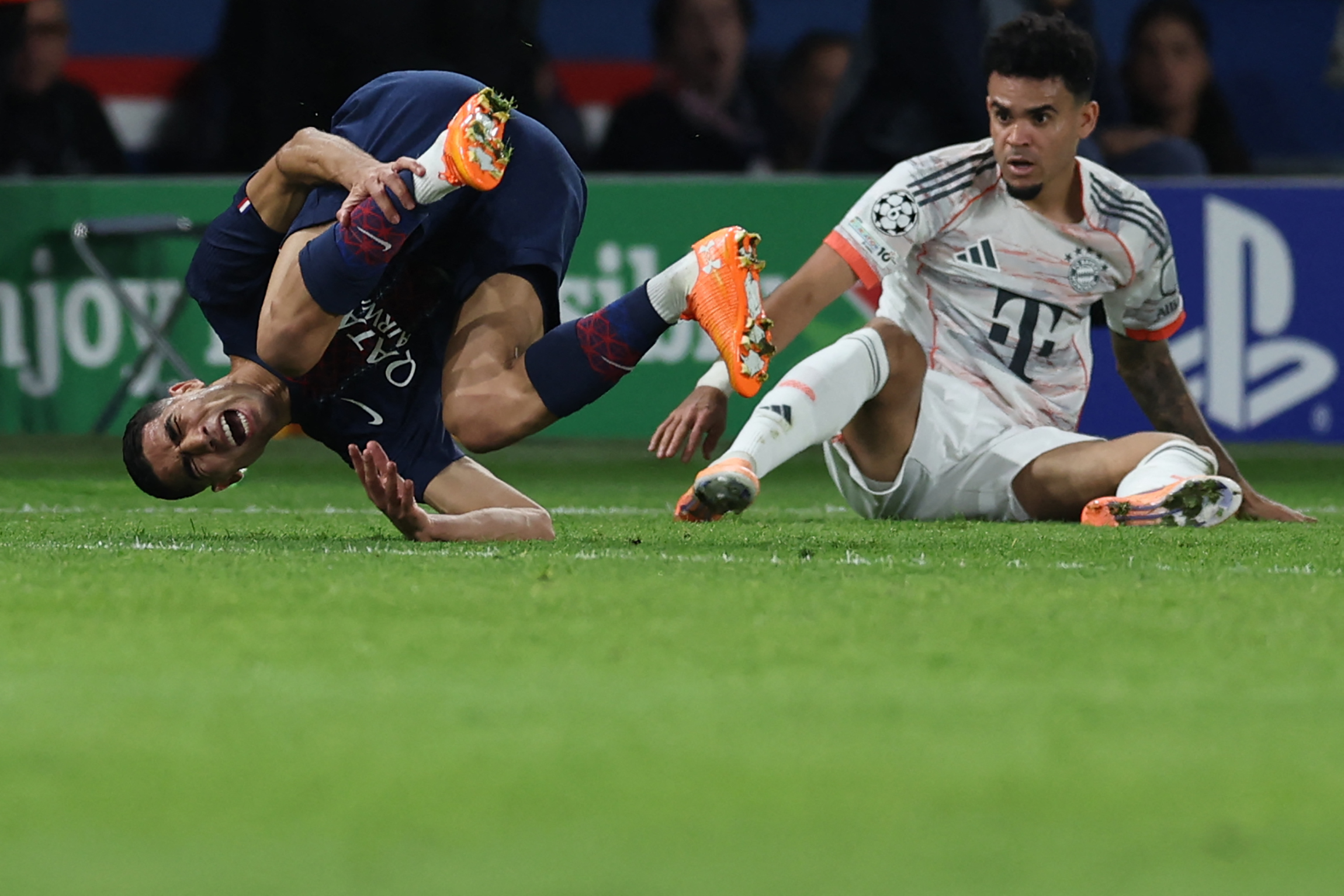 TOPSHOT - Bayern Munich's Colombian forward #14 Luis Diaz (R) tackles Paris Saint-Germain's Moroccan defender #02 Achraf Hakimi during the UEFA Champions League, league phase day 4, football match between Paris Saint-Germain (PSG) and FC Bayern Mu...