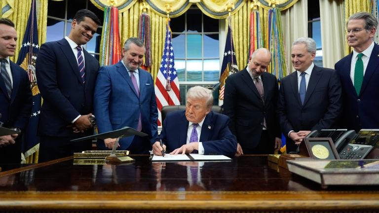 President Donald Trump signs an AI initiative in the Oval Office of the White House, Thursday, Dec. 11, 2025, in Washington. (AP Photo/Alex Brandon)