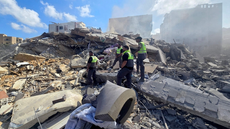 TOPSHOT - Lebanese civil defence workers search through the rubble of a building following an Israeli strike at dawn in the southern Lebanese area of al-Hosh, near the coastal city of Tyre on May 26, 2026. Israeli Prime Minister Benjamin Netanyahu...