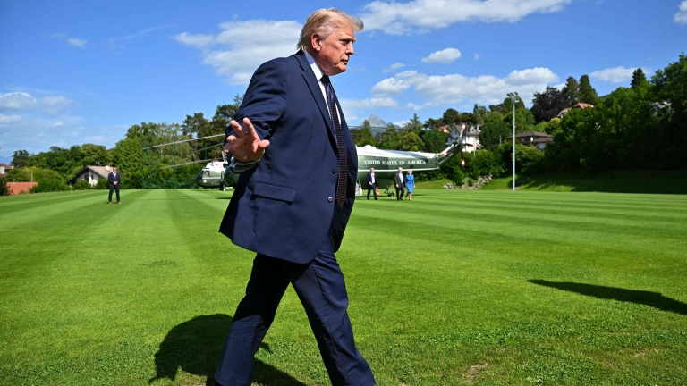 TOPSHOT - US President Donald Trump gestures after stepping off Marine One as he arrives to attend the G7 summit, in Evian, eastern France, on June 15, 2026. A G7 summit is set to take place June 15 to 17 in the French town of Evian-les-Bains near...
