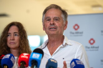 epa13318984 Phil Haines, husband of Independent MP Helen Haines, speaks to the media during a press conference at Alfred Hospital in Melbourne, Victoria, Australia, 21 October 2026. Haines confirmed that while his wife remains in stable condition,...